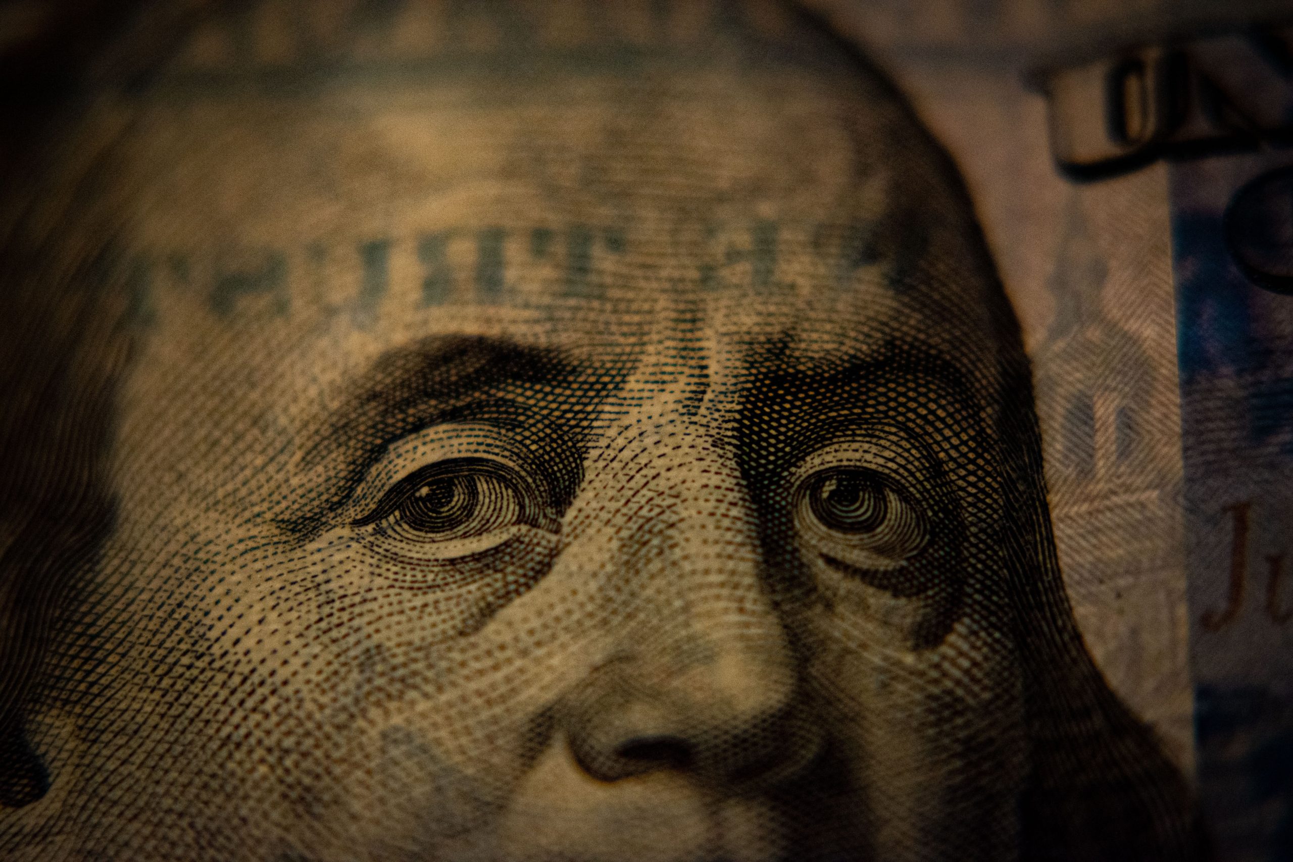 Close-up of Benjamin Franklin's face on a hundred dollar bill.