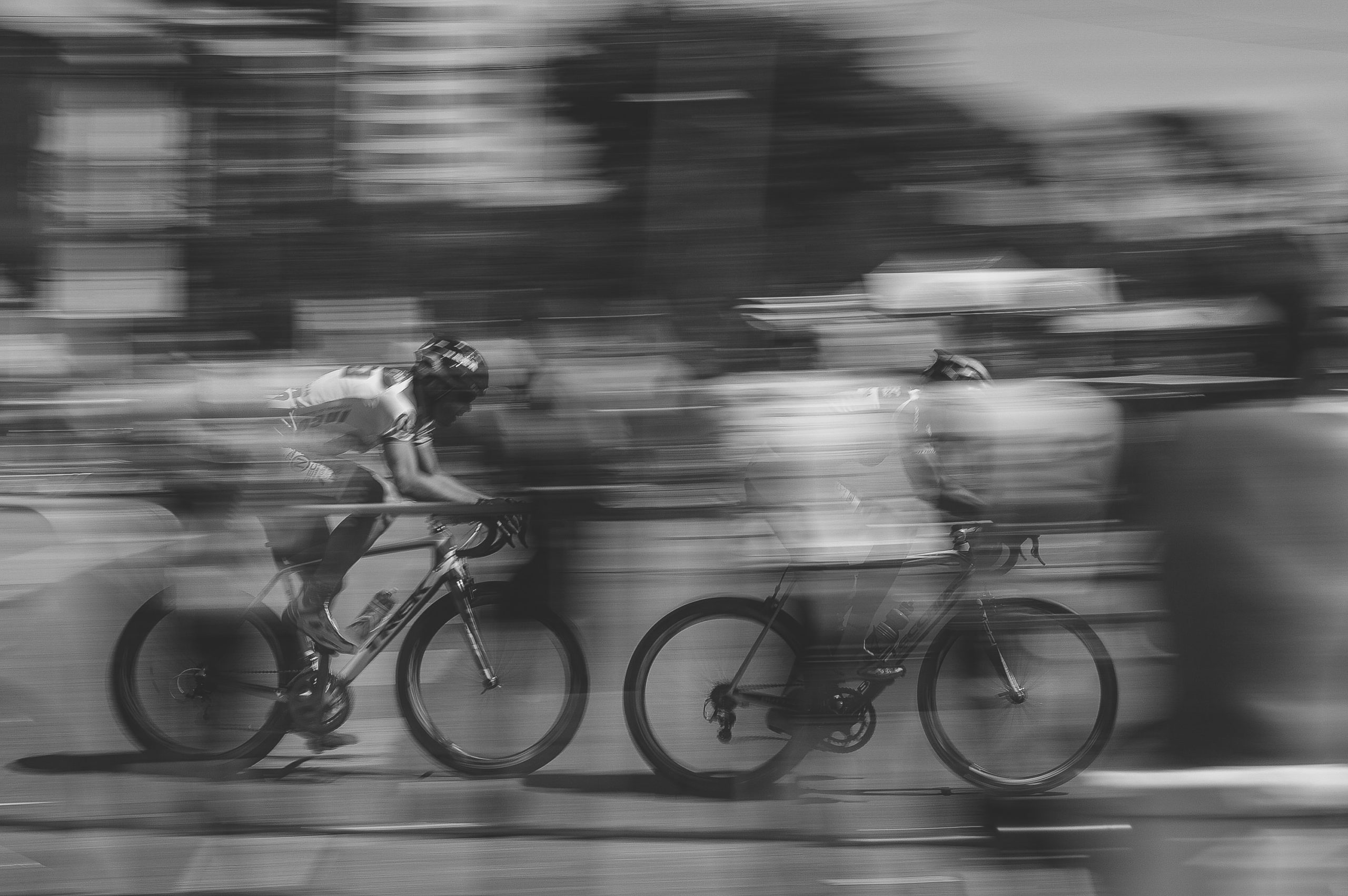 Motion blur of cyclists racing, representing fast growth and competition.