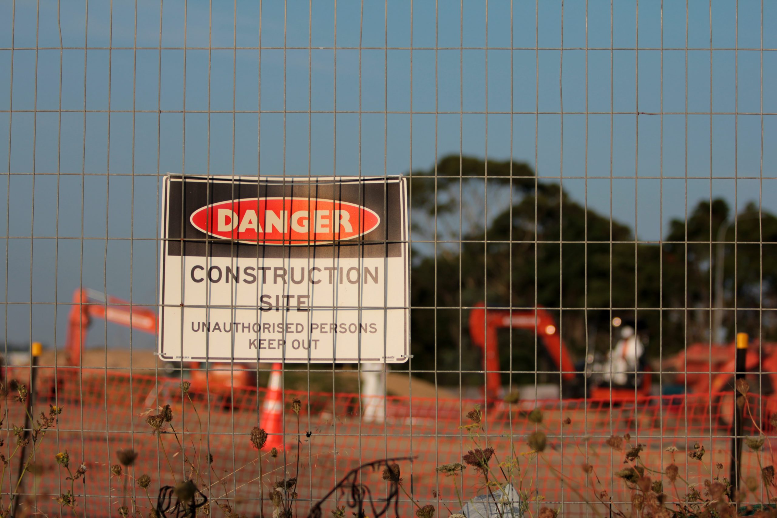4 Risks to Avoid During Preconstruction|preconstruction meeting between an engineer and architect in an office working at a desk|Barton Malow Case Study Hero|