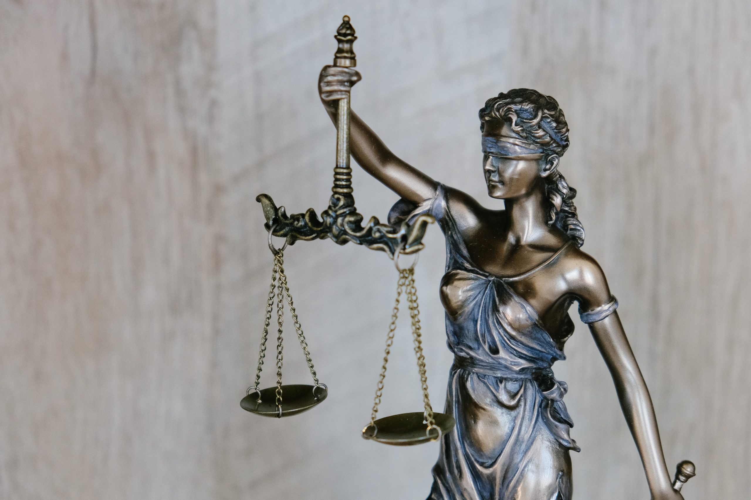 Statue of Lady Justice, blindfolded, holding scales. Symbolizes fairness and impartiality in the legal system.