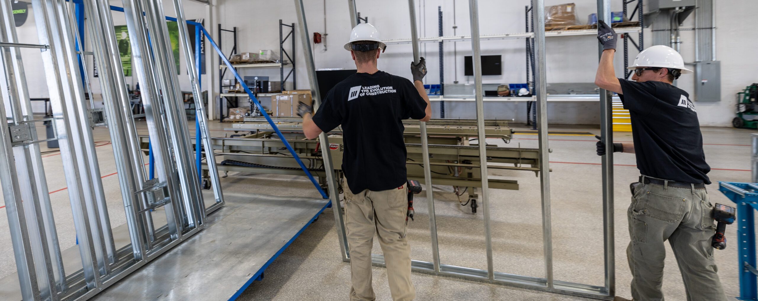 Workers assembling metal framing for healthcare clinics.