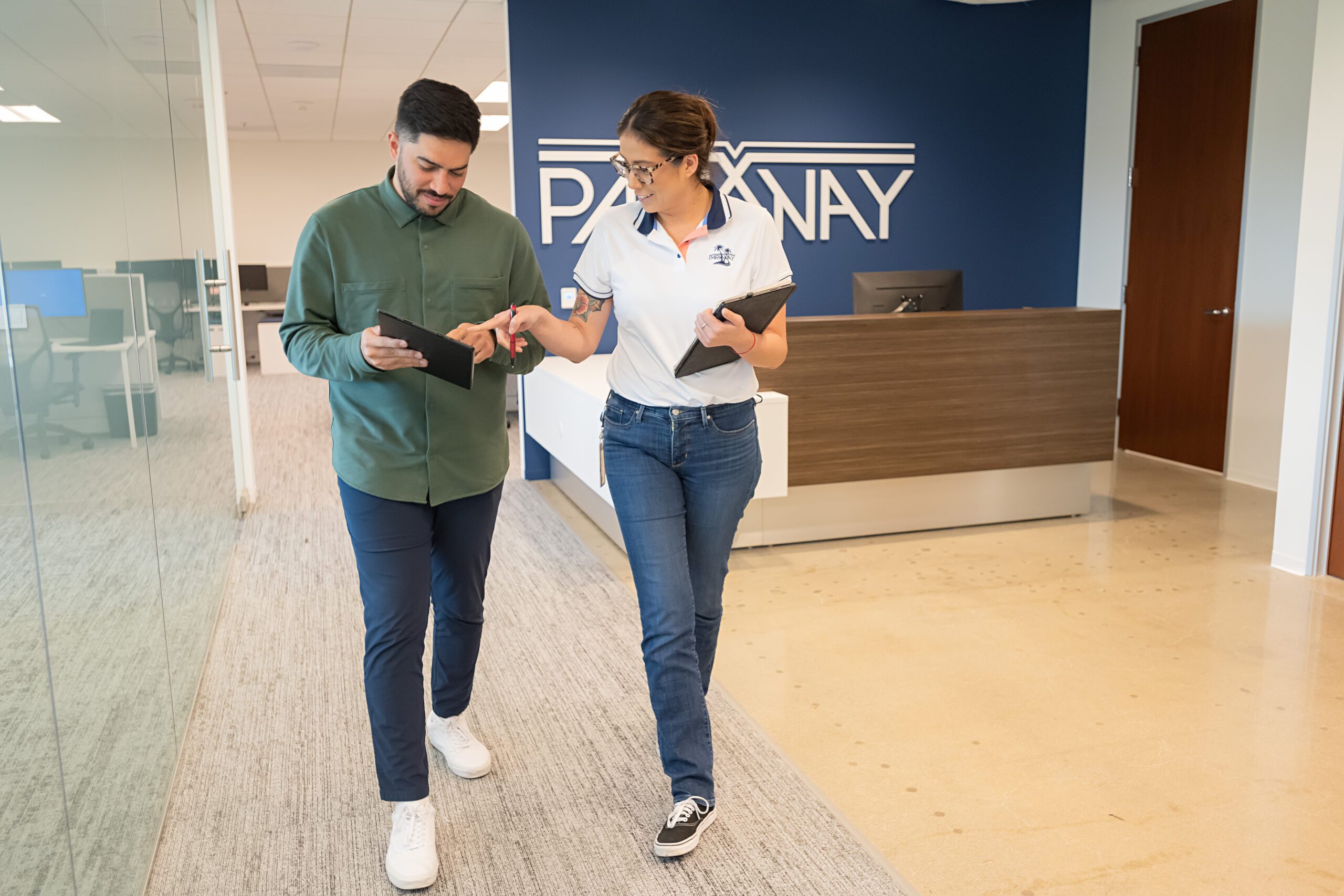 Parkway employees review project plans on a tablet in the office.